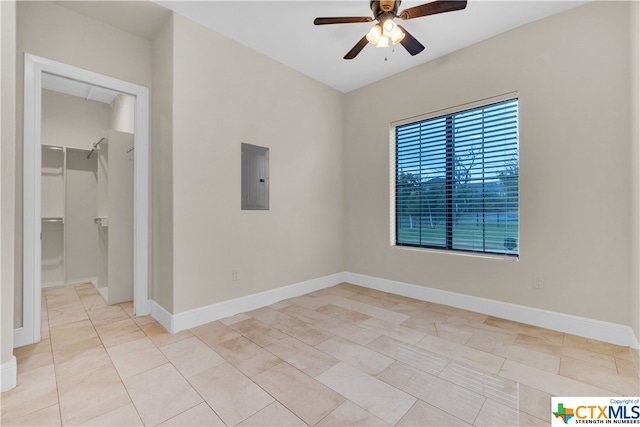 spare room featuring electric panel and ceiling fan