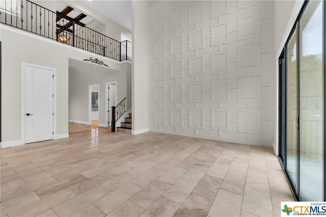 12312 White Birch St, San Antonio, TX 78245 - unfurnished living room with a high ceiling, stairway, and baseboards