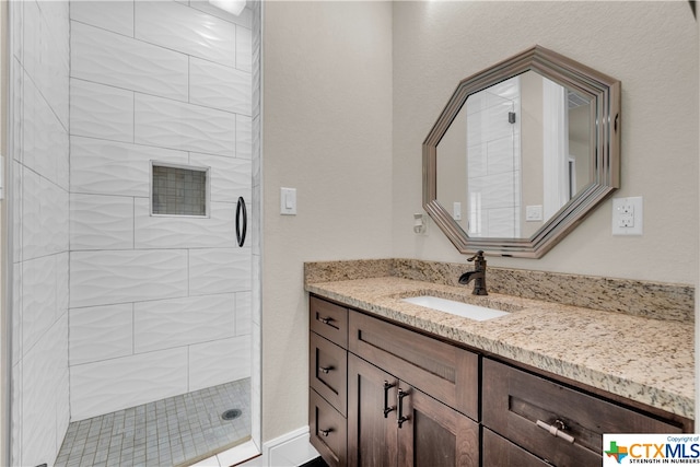 bathroom featuring vanity and a tile shower