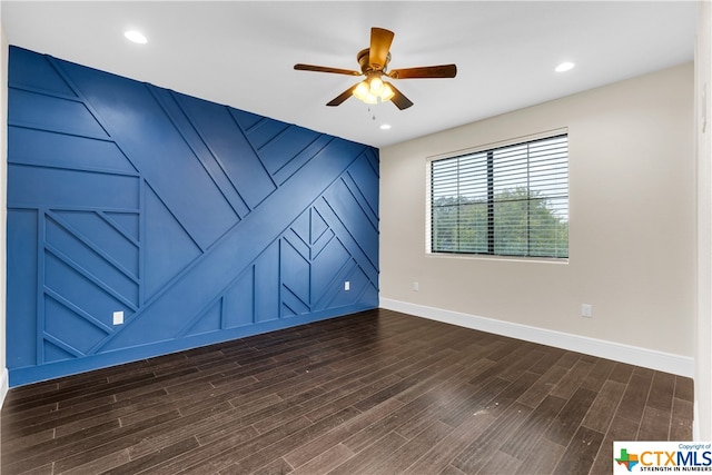 empty room featuring dark wood-type flooring and ceiling fan