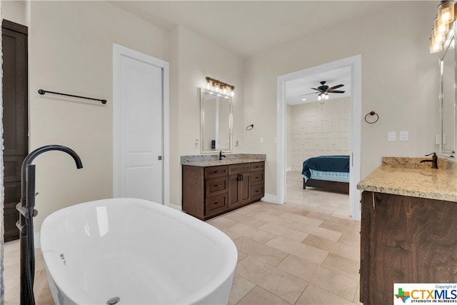 bathroom featuring ceiling fan, a tub to relax in, vanity, and tile patterned flooring