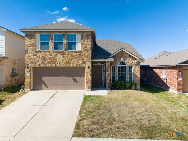 view of front of property featuring a garage and a front lawn