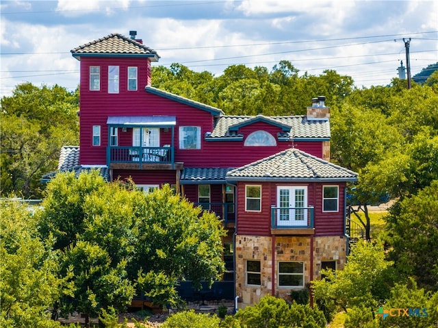 rear view of house featuring a balcony