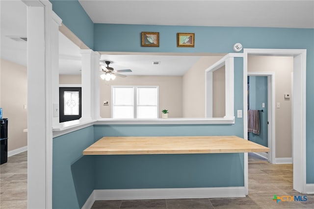 interior space with ornate columns and ceiling fan