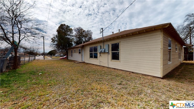 view of side of home with a lawn