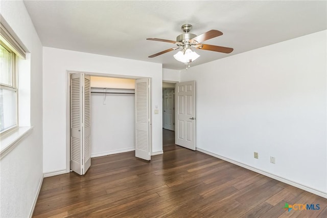 102 Norcrest Dr, San Marcos, TX 78666 - unfurnished bedroom featuring wood finished floors, a closet, multiple windows, and baseboards