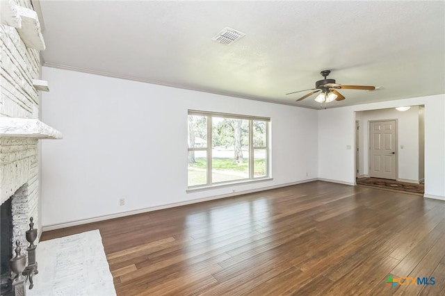 102 Norcrest Dr, San Marcos, TX 78666 - unfurnished living room featuring ceiling fan, a fireplace, wood finished floors, and baseboards