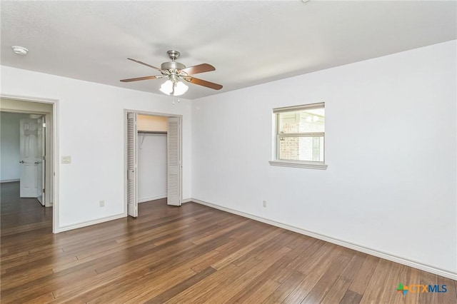 102 Norcrest Dr, San Marcos, TX 78666 - unfurnished bedroom featuring wood finished floors, baseboards, a closet, and ceiling fan