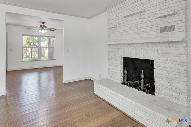 102 Norcrest Dr, San Marcos, TX 78666 - unfurnished living room featuring ceiling fan, baseboards, wood finished floors, and a fireplace with raised hearth