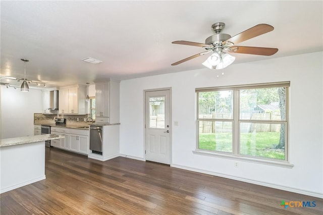 102 Norcrest Dr, San Marcos, TX 78666 - kitchen featuring stainless steel appliances, dark wood-type flooring, white cabinetry, light stone counters, and wall chimney exhaust hood
