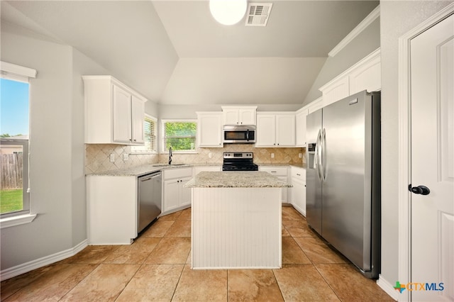 412 Coventry Dr, Temple, TX 76502 - kitchen featuring stainless steel appliances, backsplash, white cabinetry, a center island, and lofted ceiling