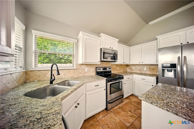 412 Coventry Dr, Temple, TX 76502 - kitchen featuring appliances with stainless steel finishes, vaulted ceiling, backsplash, plenty of natural light, and white cabinetry