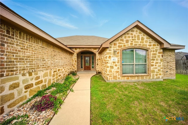 412 Coventry Dr, Temple, TX 76502 - view of exterior entry with a lawn, brick siding, and stone siding