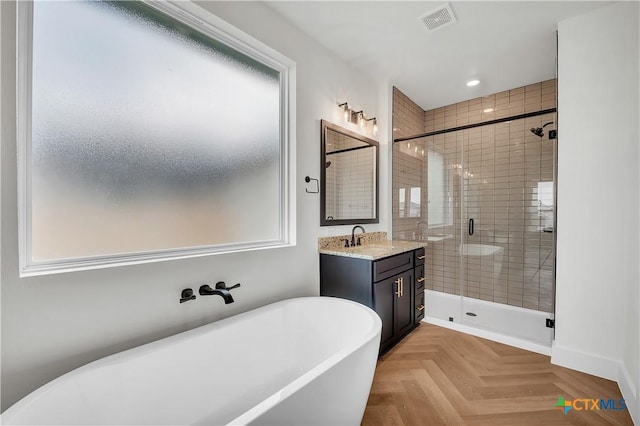 bathroom with parquet flooring, vanity, and independent shower and bath