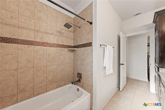 bathroom with visible vents, baseboards, and shower / bathtub combination