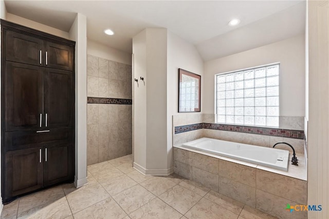 bathroom with a walk in shower, vaulted ceiling, a bath, and tile patterned floors