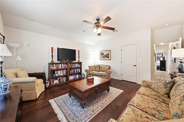 living area with a ceiling fan, visible vents, vaulted ceiling, and wood finished floors