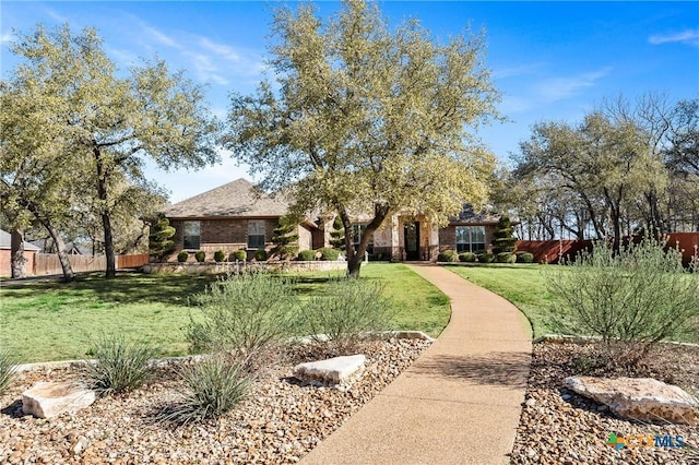 view of front of house featuring a front yard and fence