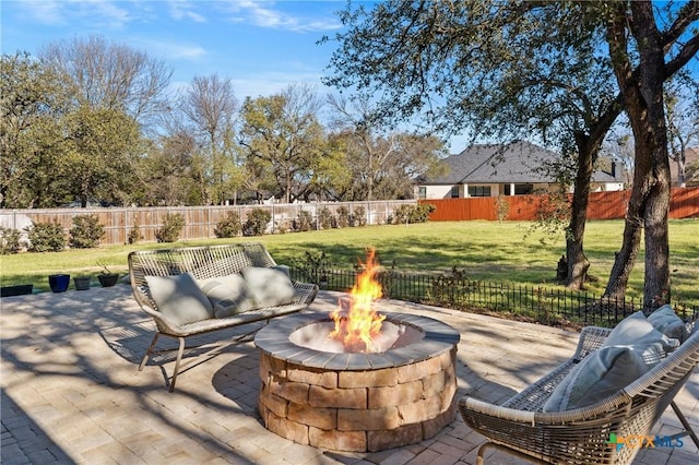 view of patio featuring an outdoor fire pit and a fenced backyard