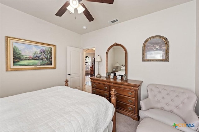 bedroom with a ceiling fan, visible vents, and carpet flooring