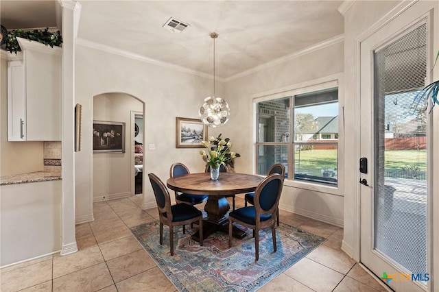 dining room with ornamental molding, arched walkways, visible vents, and light tile patterned floors