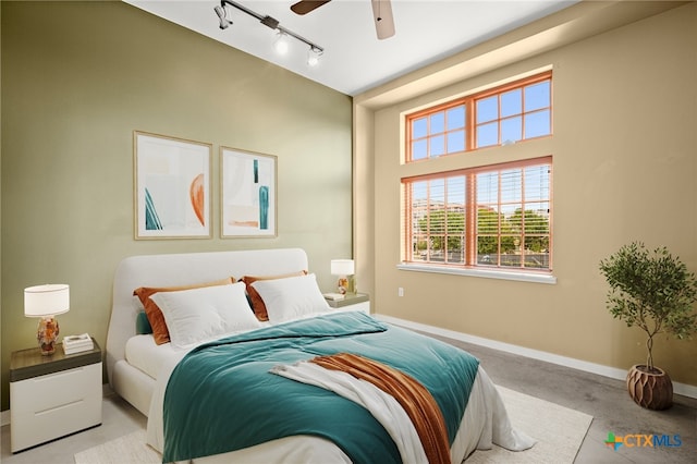 bedroom with rail lighting and ceiling fan