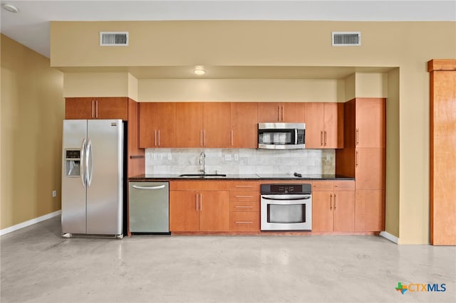 kitchen featuring decorative backsplash, sink, and stainless steel appliances