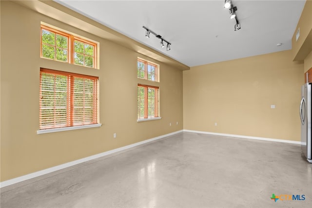 interior space featuring concrete flooring and track lighting