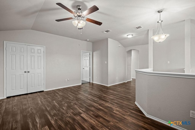 5712 Stonehaven Dr, Temple, TX 76502 - unfurnished living room featuring lofted ceiling, arched walkways, dark wood finished floors, a ceiling fan, and baseboards