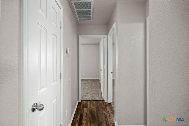 5712 Stonehaven Dr, Temple, TX 76502 - hallway with dark wood finished floors, a textured wall, and baseboards