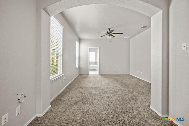 5712 Stonehaven Dr, Temple, TX 76502 - carpeted spare room with ceiling fan, baseboards, and arched walkways