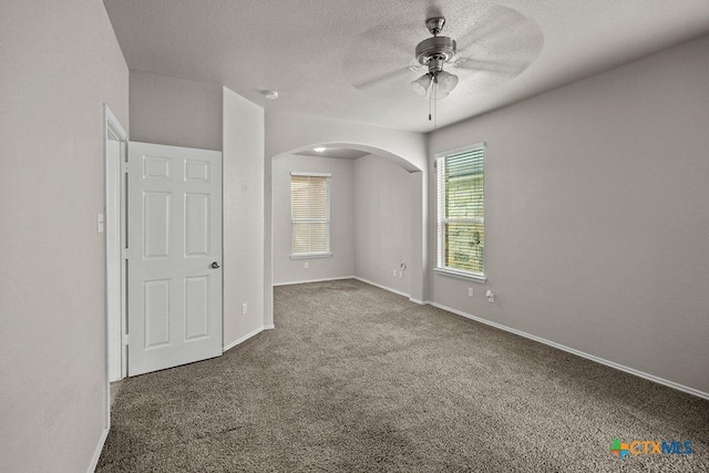 5712 Stonehaven Dr, Temple, TX 76502 - carpeted spare room featuring arched walkways, ceiling fan, baseboards, and a textured ceiling