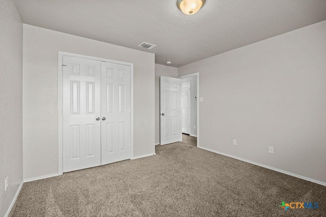 5712 Stonehaven Dr, Temple, TX 76502 - unfurnished bedroom featuring carpet floors, baseboards, a closet, and a textured ceiling