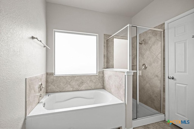 5712 Stonehaven Dr, Temple, TX 76502 - full bath featuring a shower stall, a bath, and a textured wall