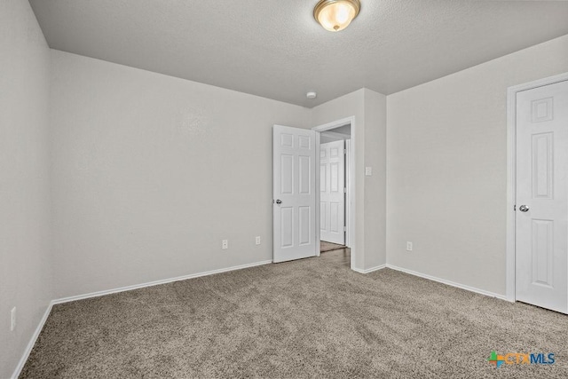 5712 Stonehaven Dr, Temple, TX 76502 - unfurnished bedroom with carpet, baseboards, and a textured ceiling