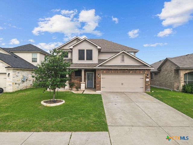 5712 Stonehaven Dr, Temple, TX 76502 - view of front of home with a front yard, driveway, brick siding, and a garage