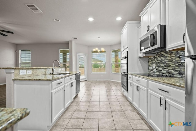 5712 Stonehaven Dr, Temple, TX 76502 - kitchen with black appliances, a sink, tasteful backsplash, a chandelier, and recessed lighting