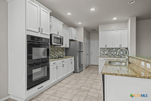 5712 Stonehaven Dr, Temple, TX 76502 - kitchen with stainless steel appliances, a sink, backsplash, white cabinets, and recessed lighting