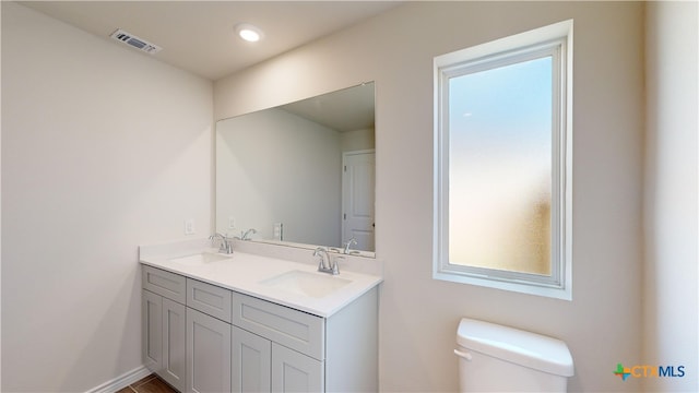 bathroom featuring vanity and toilet