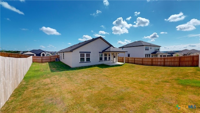 rear view of house with a lawn