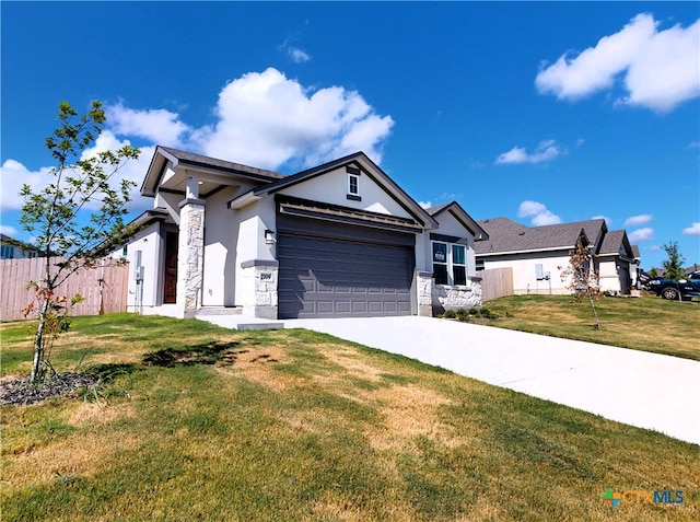 view of front of home with a front lawn and a garage