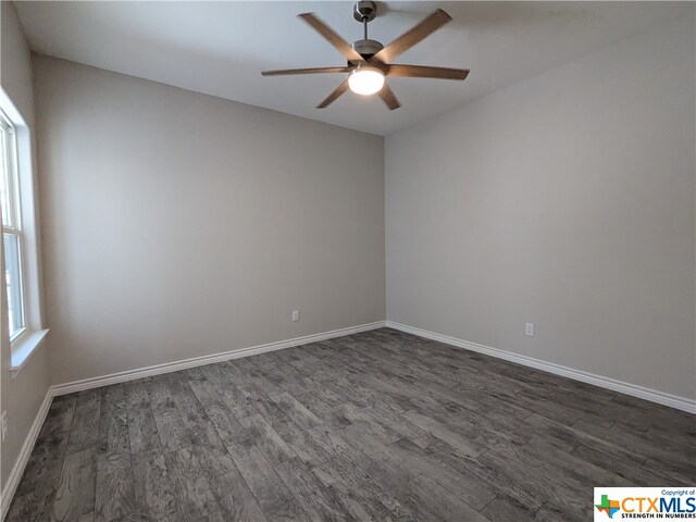 unfurnished room with dark wood-type flooring and ceiling fan