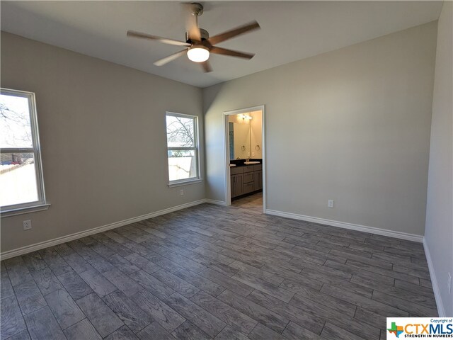 empty room featuring dark wood-type flooring and ceiling fan