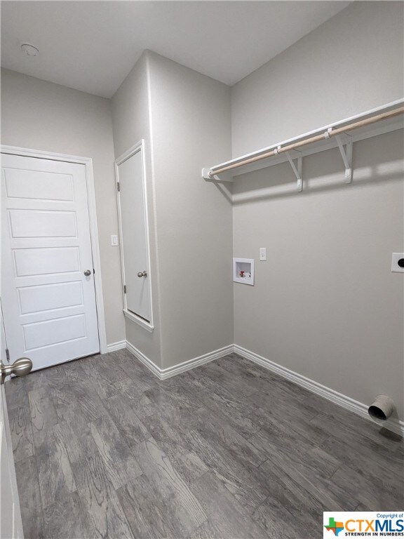 laundry area with hookup for a washing machine, electric dryer hookup, and dark hardwood / wood-style flooring