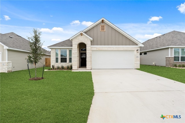 view of front of house with a garage and a front lawn