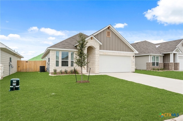 view of front of property with a garage, cooling unit, and a front yard