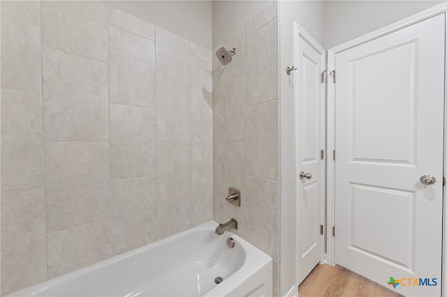 bathroom featuring tiled shower / bath and hardwood / wood-style flooring