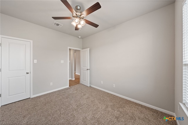 unfurnished bedroom featuring ceiling fan and carpet floors