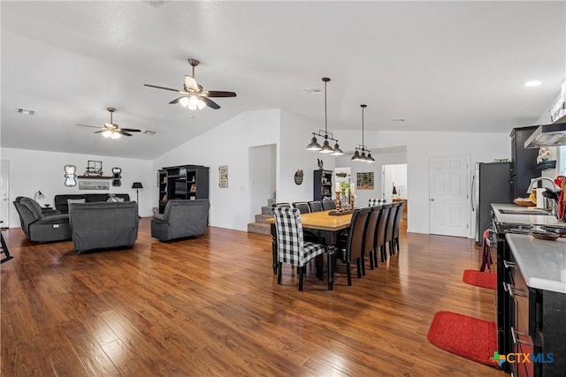 dining area with visible vents, dark wood-style floors, and lofted ceiling