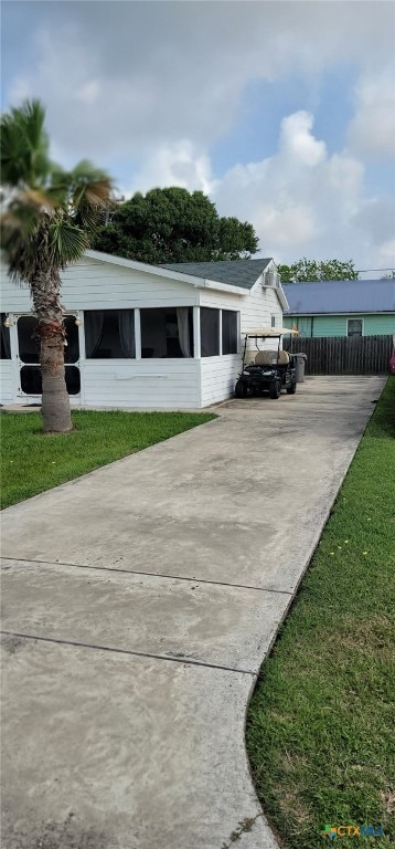 101 E Saint Louis Ave, Seadrift, TX 77983 - view of side of home featuring driveway and a sunroom